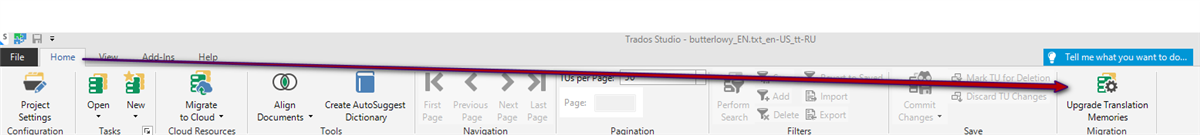 Screenshot of the Trados Studio interface with a purple arrow pointing to the 'Upgrade Translation Memories' option in the toolbar.