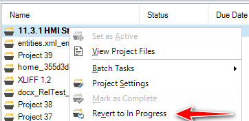 Screenshot of Trados Studio showing a right-click context menu with 'Revert to In Progress' option highlighted by a red arrow.