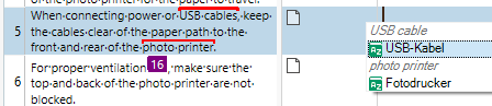 Trados Studio screenshot showing a segment with the term 'photo printer' highlighted and a list of translated terms including 'USB cable' and 'photo printer' in different languages.