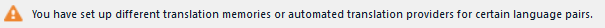Warning message in Trados Studio indicating different translation memories or automated translation providers set up for certain language pairs.