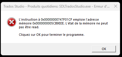 Error dialog box in Trados Studio with a memory access error message in French, indicating the instruction at a specific memory address could not be read, with an OK button to terminate the program.