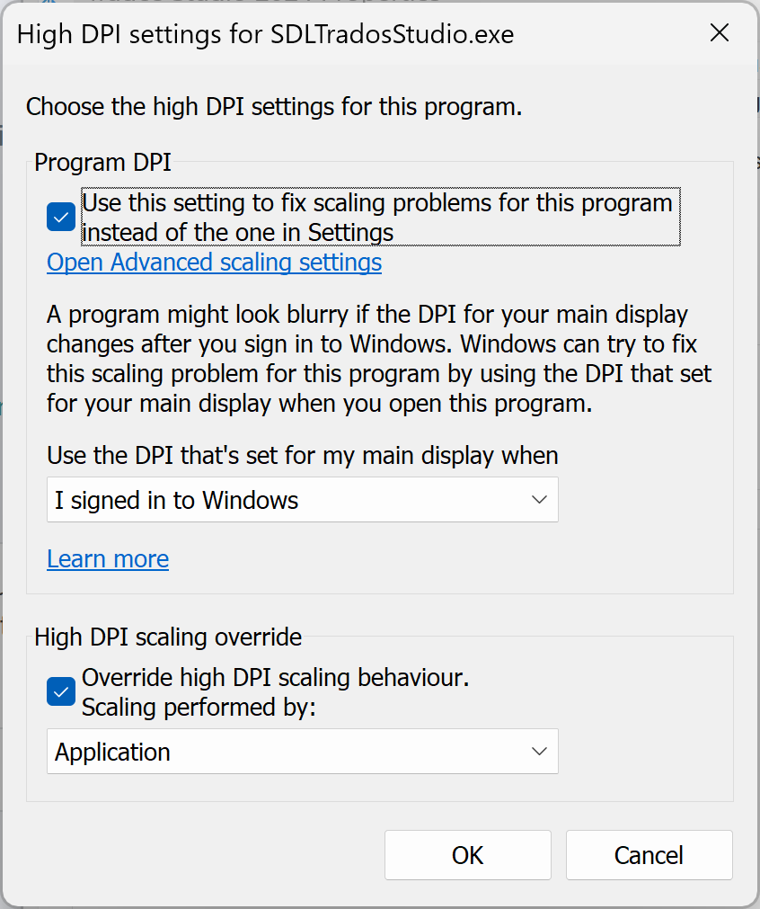 High DPI settings dialog for SDLTradosStudio.exe with options to fix scaling problems, including an advanced scaling settings link and a DPI scaling override section.