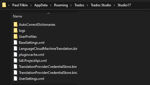 File Explorer window showing Trados Studio folder contents with folders such as AutoCorrectDictionaries, logs, UserProfiles, and files like BaseSettings.xml, LanguageCloudMachineTranslation.bir.