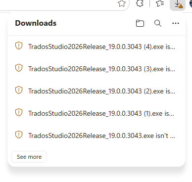 A screenshot of the Downloads panel showing multiple files named TradosStudio2026Release_19.0.0.3043.exe with warnings stating the files are not commonly downloaded.