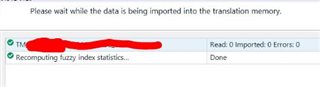 Trados Studio message displaying 'Please wait while the data is being imported into the translation memory' with a progress bar and a message below stating 'Recomputing fuzzy index statistics... Done'. A green checkmark is visible, and the import summary shows 'Read: 0 Imported: 0 Errors: 0'.