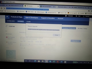Screenshot of Trados Studio showing a 'Process Upgrade' pop-up with a message instructing to return any in-use activations before proceeding.