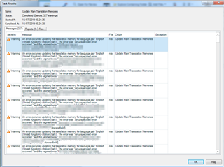 Screenshot of Trados Studio showing a Task Results window with multiple warnings about an unspecified error updating the translation memory for language pair English to Spanish.