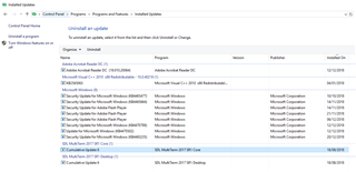 Control Panel window showing 'Programs and Features' with a list of 'Installed updates'. Trados Studio updates not visible in the list.