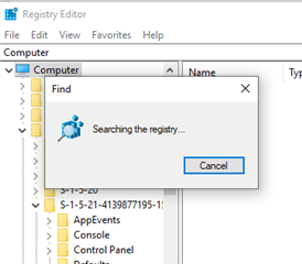 Registry Editor displaying a progress window with a magnifying glass icon indicating 'Searching the registry...'