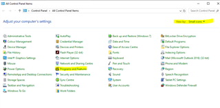 Control Panel window with 'View by: Small icons' selected. 'Programs and Features' is highlighted among other system settings options.