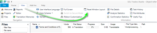 Trados Studio screenshot showing the 'Reset Window Layout' option highlighted with a green arrow pointing towards it.