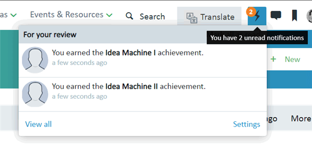 Notification dropdown showing two messages: 'You earned the Idea Machine I achievement.' and 'You earned the Idea Machine II achievement.' both a few seconds ago.