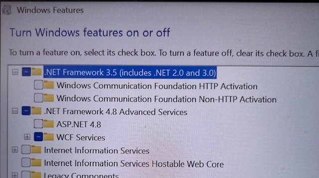 Windows Features dialog box with '.NET Framework 3.5 (includes .NET 2.0 and 3.0)' partially checked and other items listed.